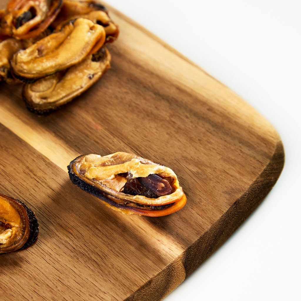 Green lipped mussels dog treats on cutting board