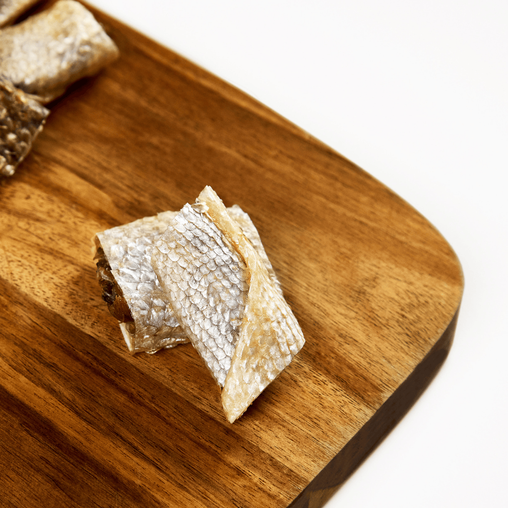 Salmon skin dog treats on cutting board